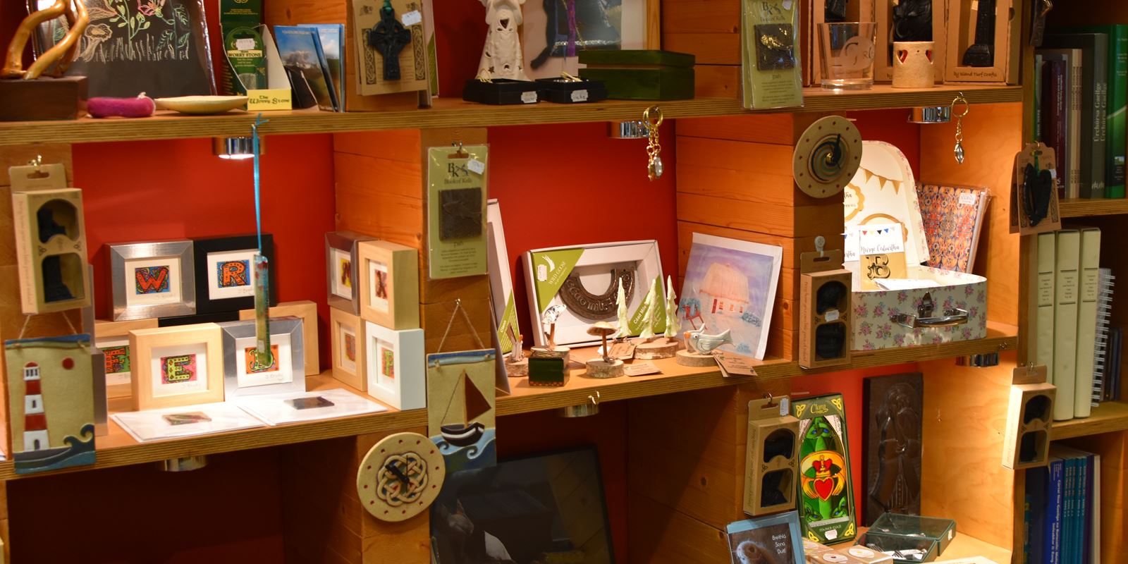 Handmade Celtic crosses, bronze ornaments and glass in An Ceathrú Póilí, Belfast bookshop.